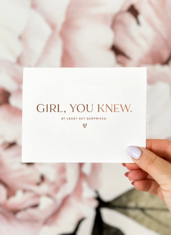 Funny bridesmaid proposal card with the text 'Girl, you know, at least act surprised’ in a modern font with a small heart below. Perfect for fun and modern bridesmaid and bridal party proposals.