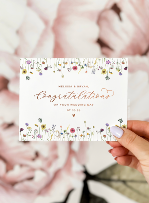 A beautifully designed custom wedding day card featuring elegant floral illustrations and personalized details, perfect for celebrating the newlyweds.